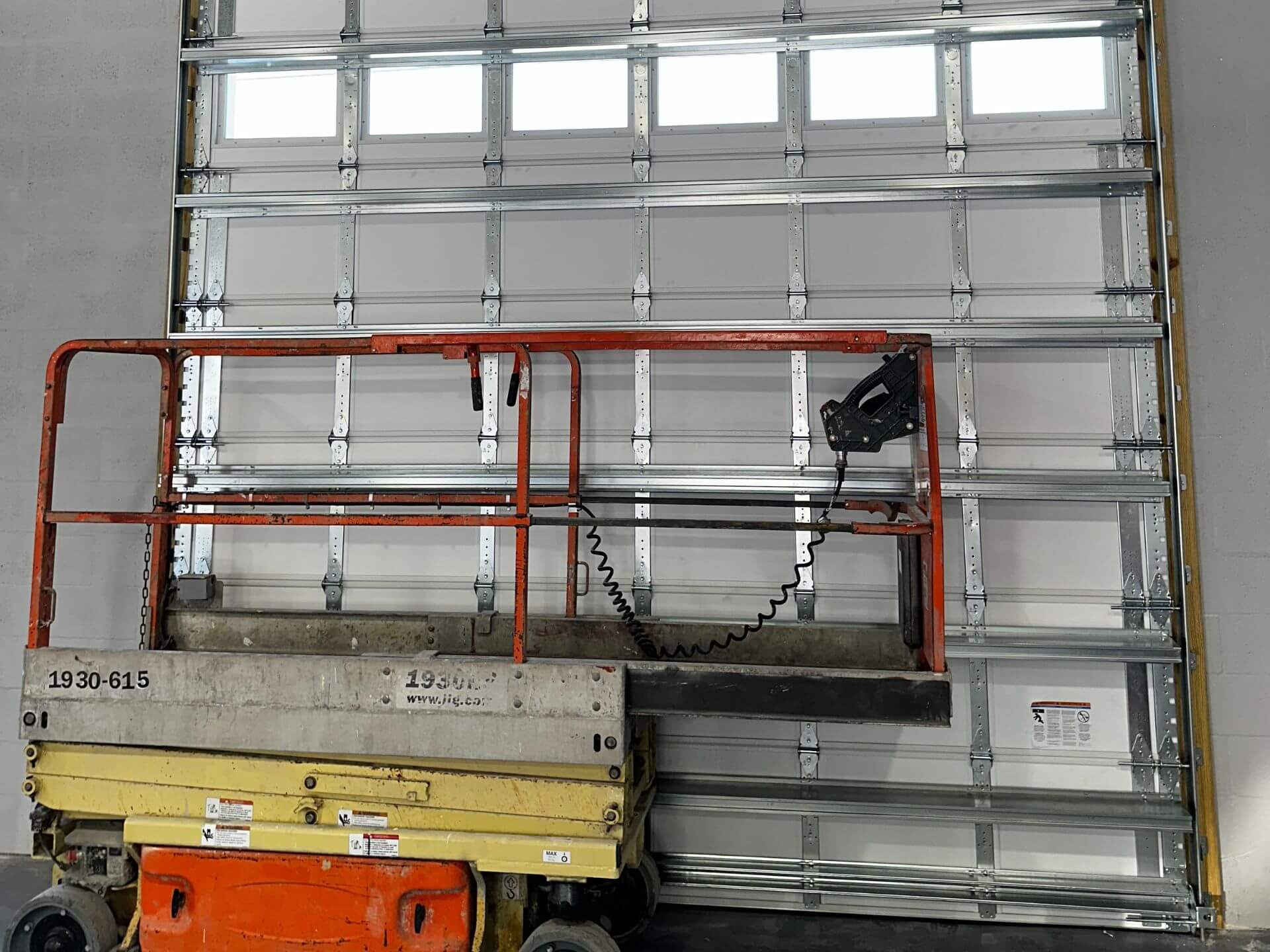 scaffolding in front of commercial garage door