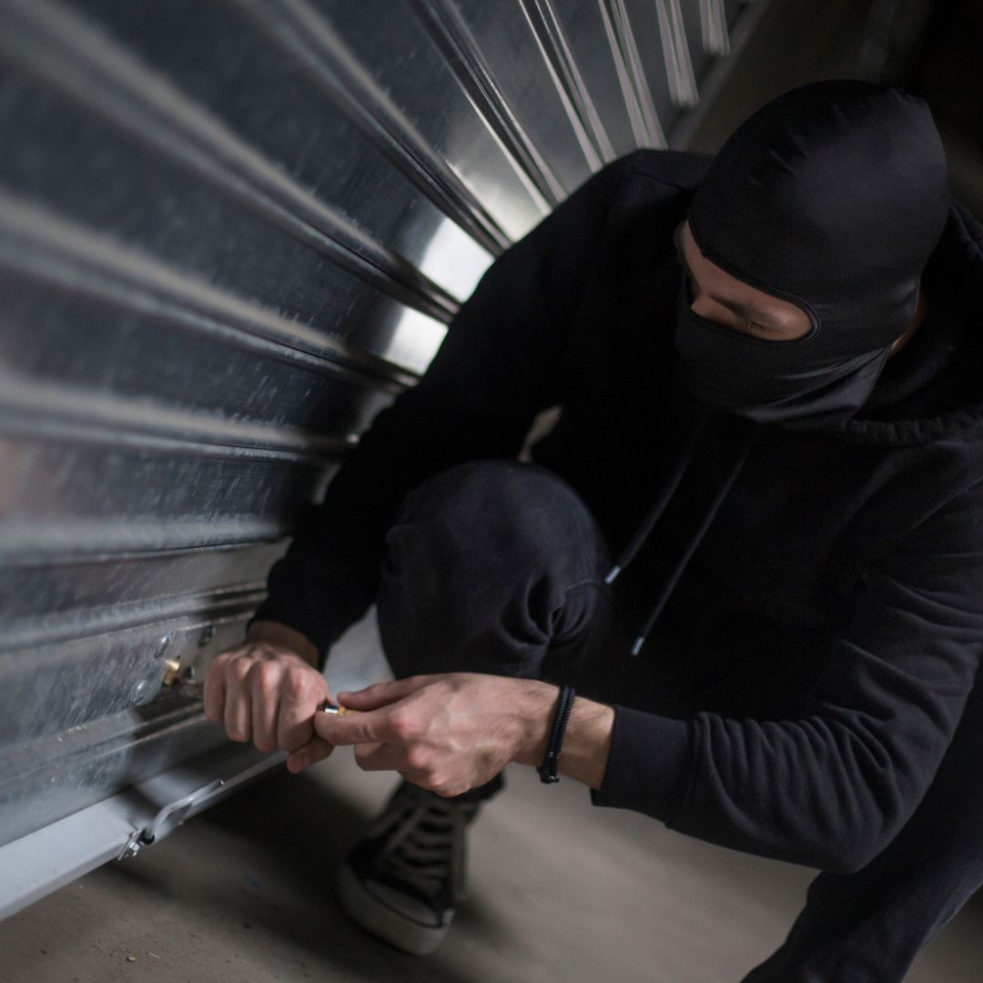 A thief breaking into a a garage