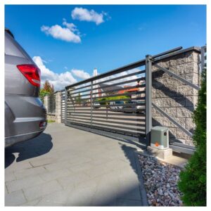 back end of car and electric security gate closing behind it