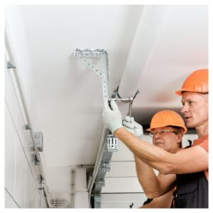 2 workers checking garage door track