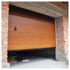 heavy-duty-looking wood garage door opening to a brick garage