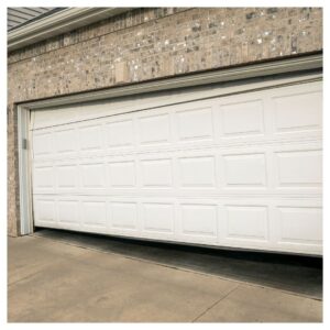 White broken residential garage door in need of repair