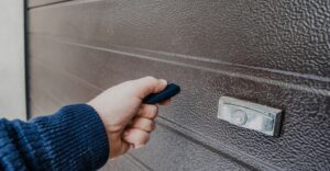 Electric remote being used on a high impact garage door